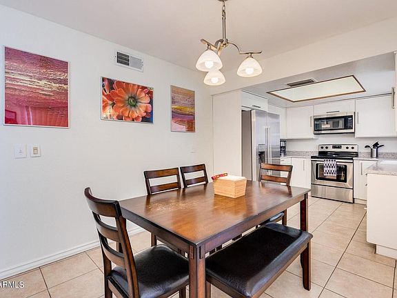 Kitchen with dining area and dining table / chairs, fridge, oven microwave view..