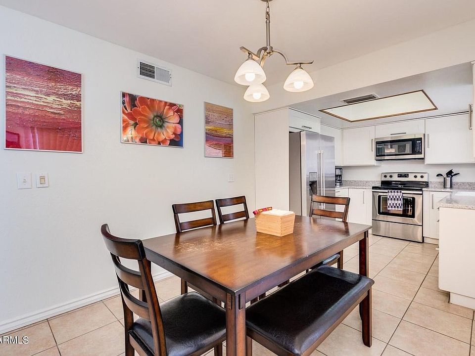 Kitchen with dining area and dining table / chairs, fridge, oven microwave view..