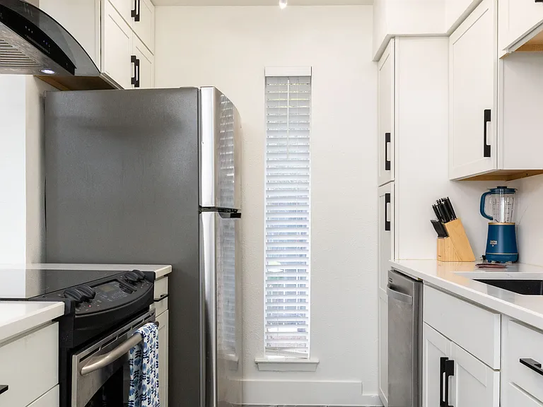 Cook with ease in this modern kitchen featuring stainless steel appliances, sleek countertops, and stylish cabinetry. Fully equipped for meals and late-night snacks.
