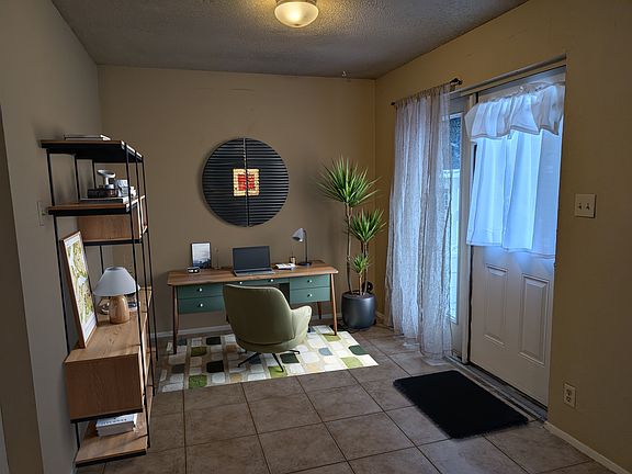 This entry foyer has room for a home office or alternatively some people put a dining table here. See other photos for example. Staged furnishings.