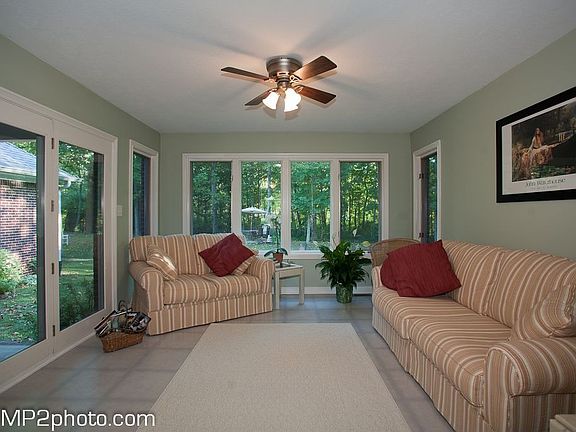 All-weather room overlooking back yard, firepit, and creek