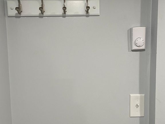 Each room has its own thermostat for controlling heat and coat hook unit installed at the entry.