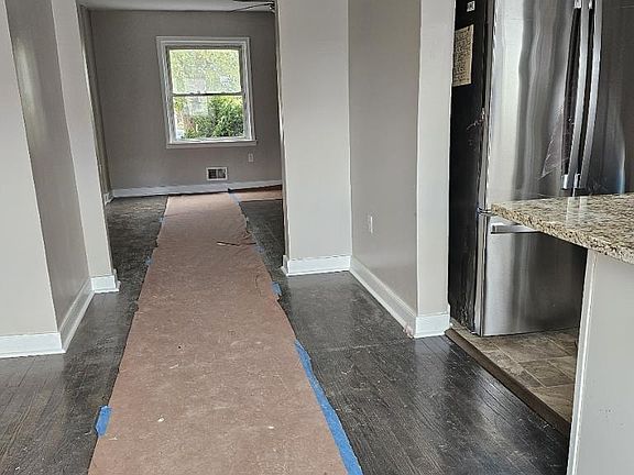 Standing in dining/kitchen area looking into living room.