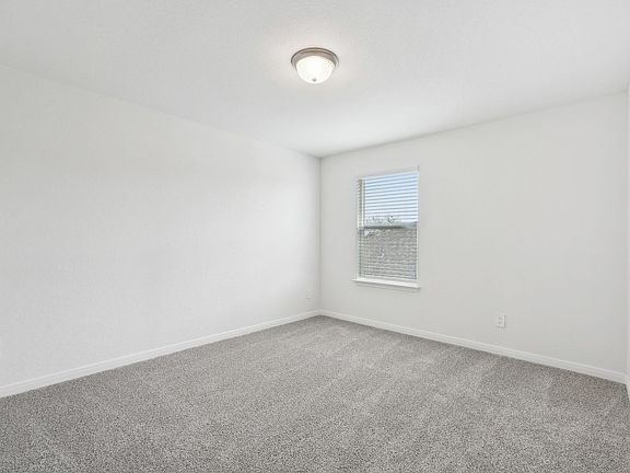 Guest bedroom in the Sabine floorplan at a Meritage Homes community.