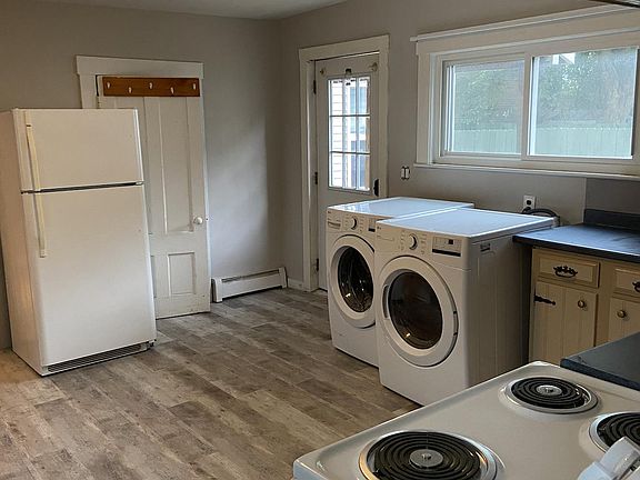 Kitchen, view 3; view from dining room entrance, plenty of cabinet space, new stove, washer/dryer and flooring, fresh coat of paint.