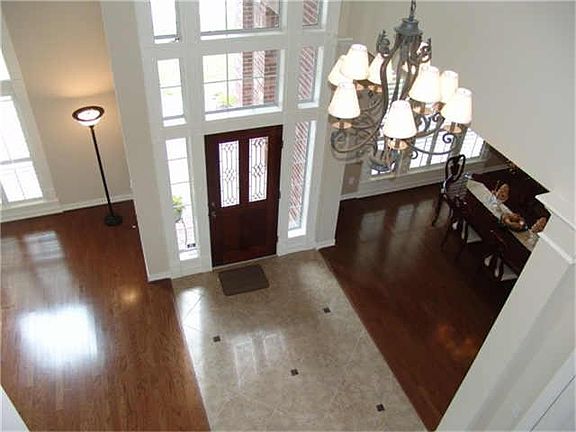 DRAMATIC ENTRY WITH 2 STORY WINDOWS & PLANTATION SHUTTERS.
