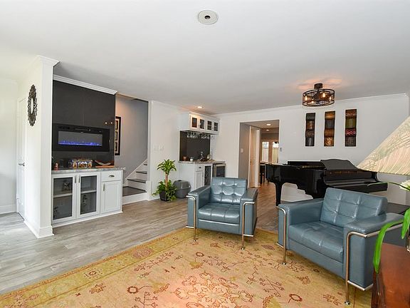 Notice the electric fireplace and dry bar with wine fridge and additional storage!