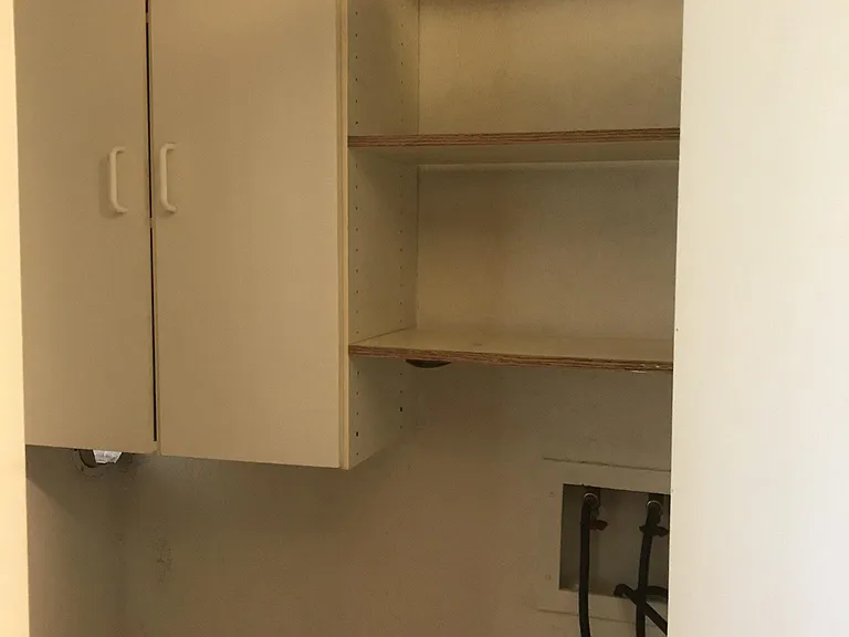 Built in cabinets and shelving in laundry room.