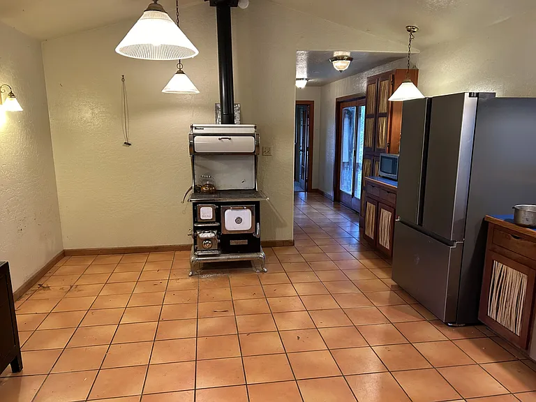 This vintage cook stove provides secondary heat and has a working wood fired oven.
