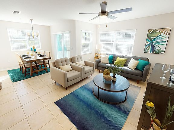 Model at Amberton Townhomes featuring a ceiling fan and windows