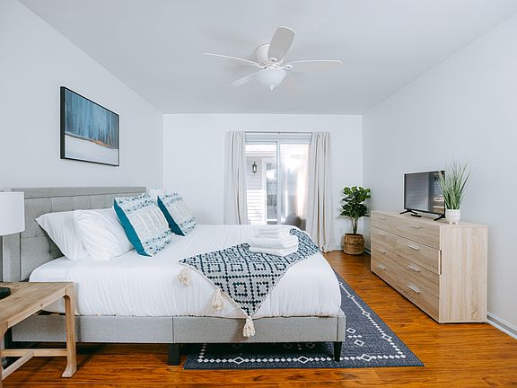 Master bedroom with King bed, Smart TV, and access to the patio