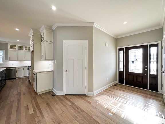 Foyer entry and doorway to garage