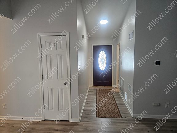 Living room towards front door. The rug stays.
