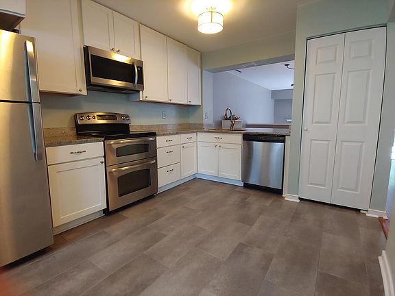 Modern updated kitchen with granite countertops, stainless still appliances, updated cabinets and flooring.