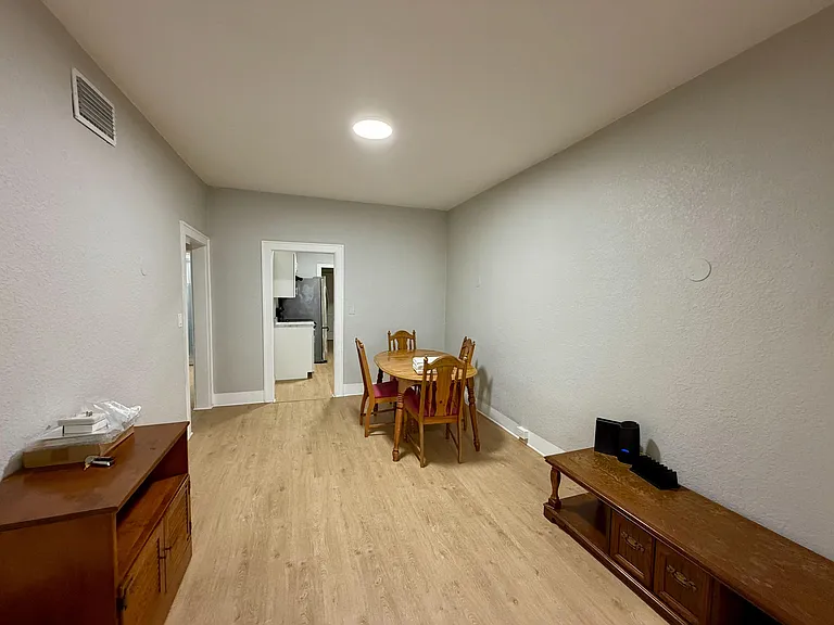 Dedicated dining area with wood-look flooring and space for a table set, conveniently positioned next to the kitchen.