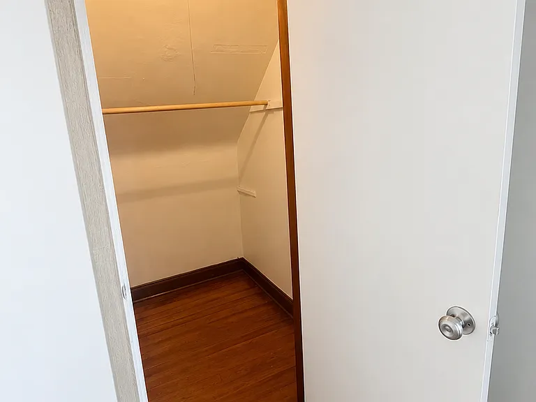 The living room also has a walk-in storage closet large enough for jackets, shoe racks, and an assortment of personal supplies.