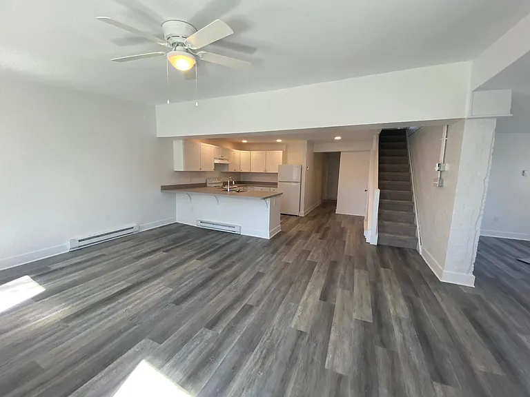 Dining/family room looking into kitchen and up stairs