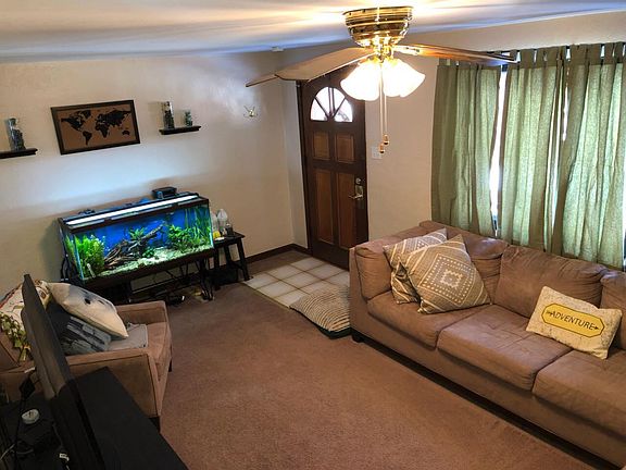 Living room after tenant decorated, looking at front window and front entry door.