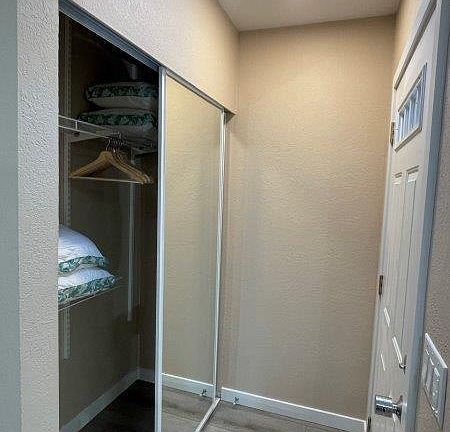Large closet with new mirror doors.