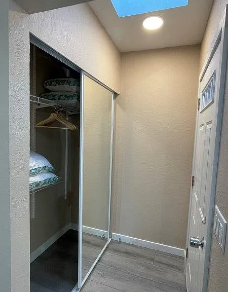 Large closet with new mirror doors.