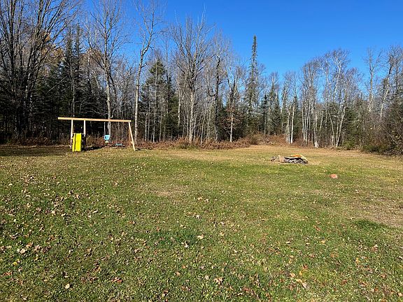 yard with swing set and fire pit