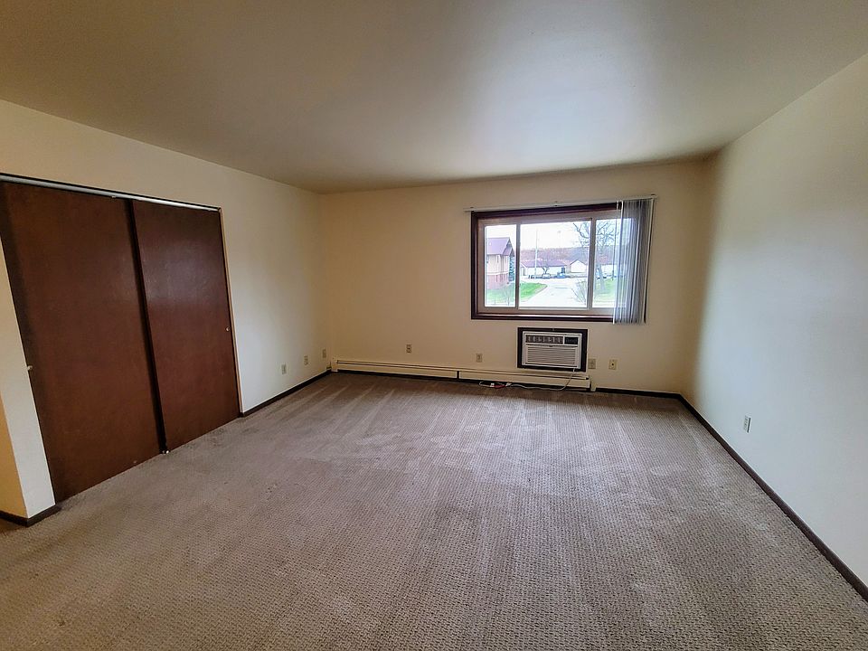 Living room features a closet and an AC unit