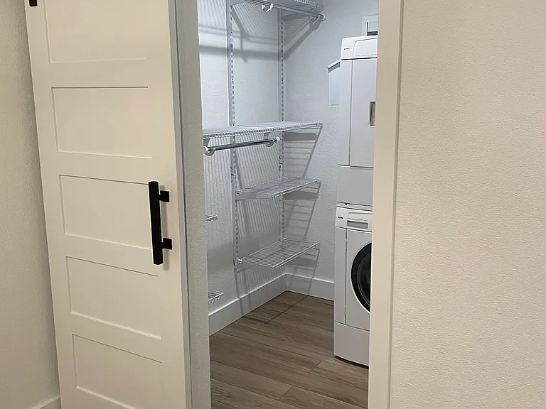 Walk-in closet with WD and shelving system.