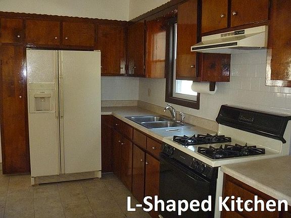 L-shaped kitchen with updated floor and counters