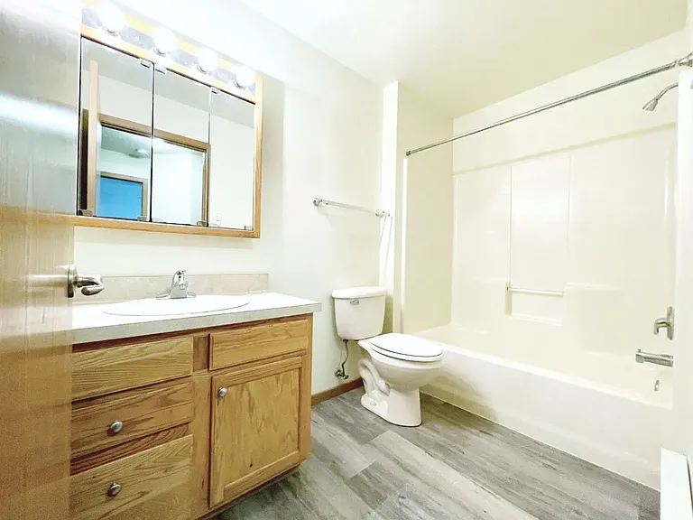 Step into the spacious, modern bathroom at Southdale Apartments, featuring sleek fixtures and a bright, welcoming design. Perfect for your daily routine, this space combines comfort and style. Schedule your tour today to see your new home!