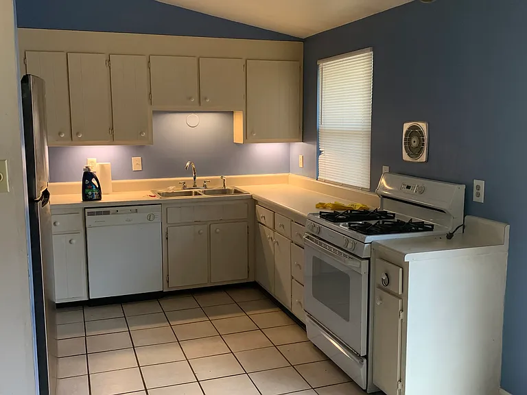 Kitchen with Range, dishwasher and refrigerator on left