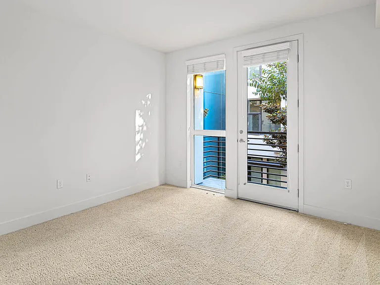 Carpeted Bedroom with Balcony