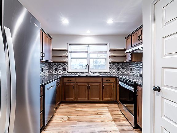 A nice new kitchen, microwave and a gas stove.