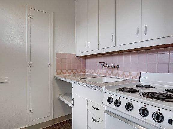 Kitchen with Pink Tile Backsplash