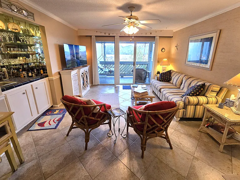 Living room with a brand new 55-inch Samsung Smart TV, wet bar and a georgeous view of the marsh.