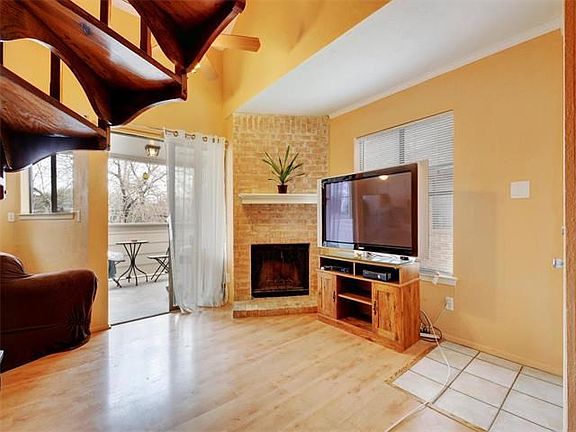 Corner fireplace with brick surround.