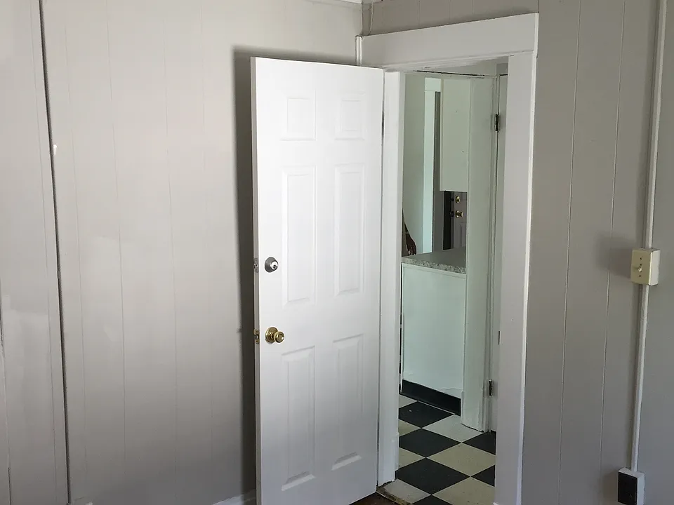 Bedroom near bathroom that is off of the kitchen