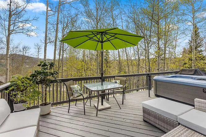 Back deck off of main level, with hot tub and outdoor furniture