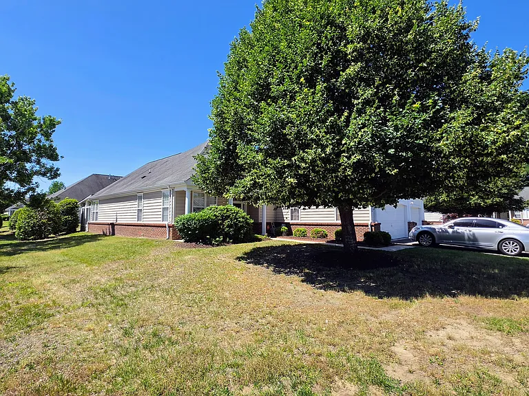 Beautifully situated corner lot boasting sweeping green spaces and mature trees in a quiet, highly desirable neighborhood.