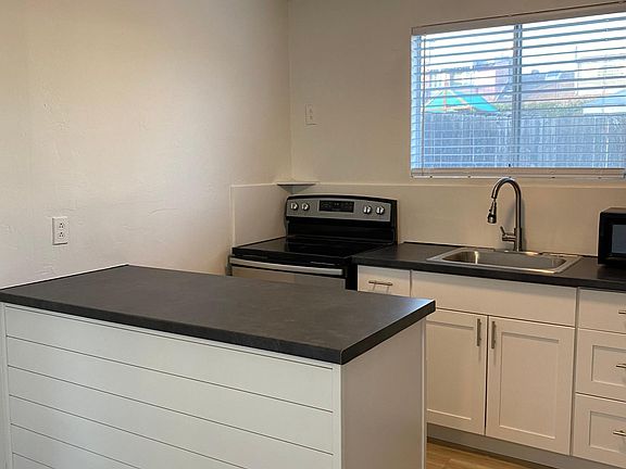 New center island with spacious countertop and shiplap decor