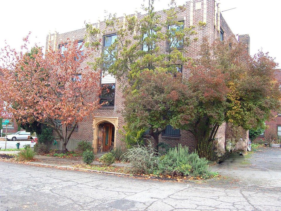 The Stanford - a 1920s building with classic stone archway and cornice details