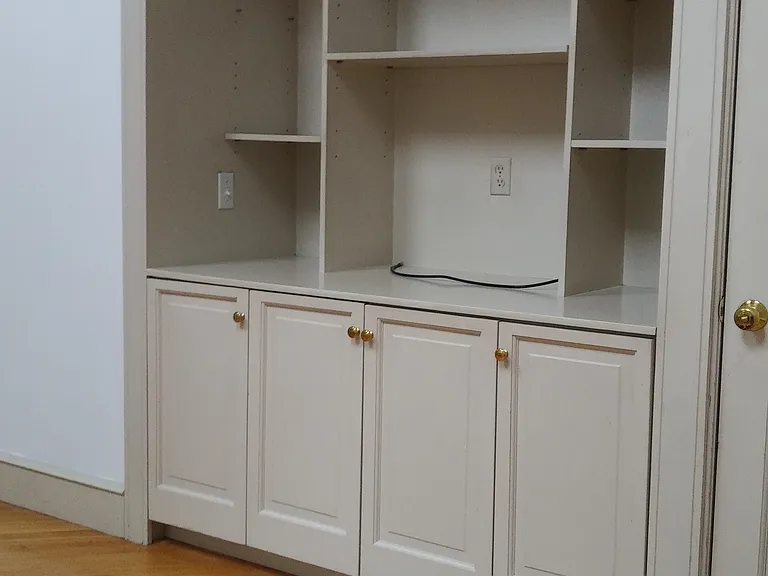 Den with shelves and console.