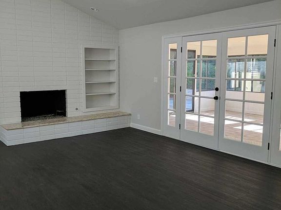 Open floor plan with fireplace across from kitchen, in famil