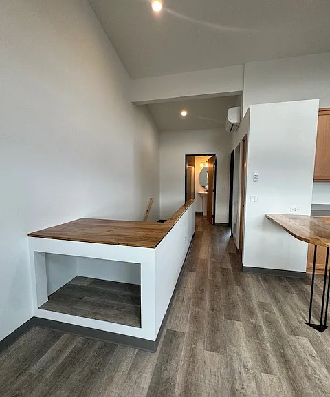 from front of unit hall to bathroom and bedroom. The table is made out of trees removed from site.