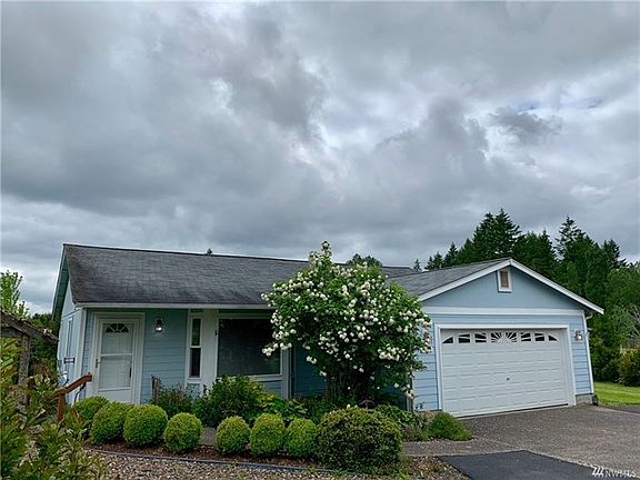 Close up of front entry with a bay window.