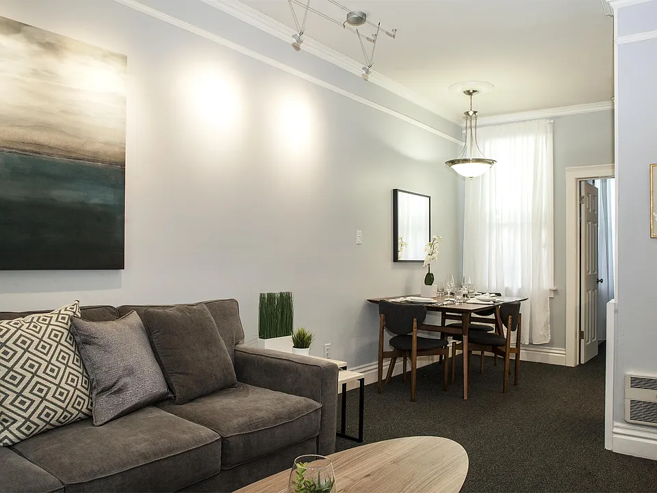 Living room, looking towards dining area; entrance door to right of photo