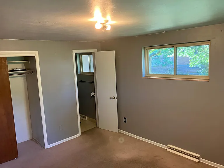 Master bedroom view into closet ad bathroom