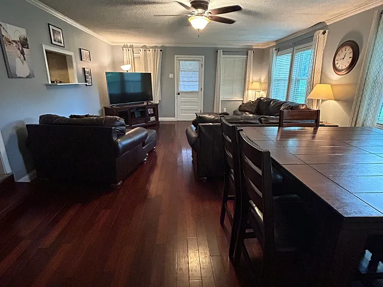 This view of the main living room shows the back door that leads out onto the deck and to the backyard oasis.