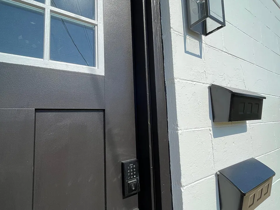 Front door with keyless entry and new, contemporary outdoor lighting.