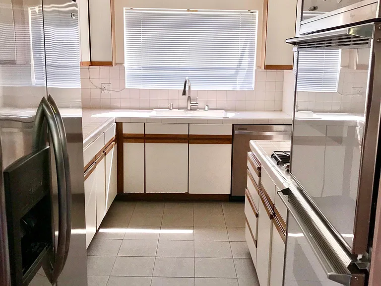 updated kitchen with recessed lighting and garden window