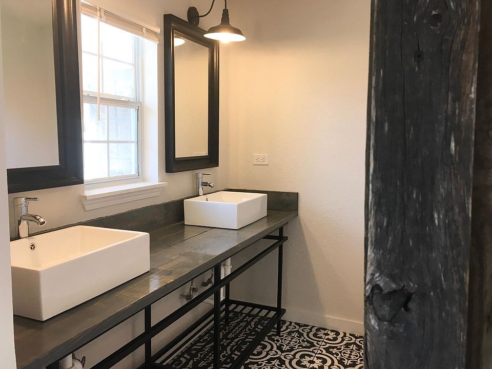 Master bathroom with vessel sinks and barn door